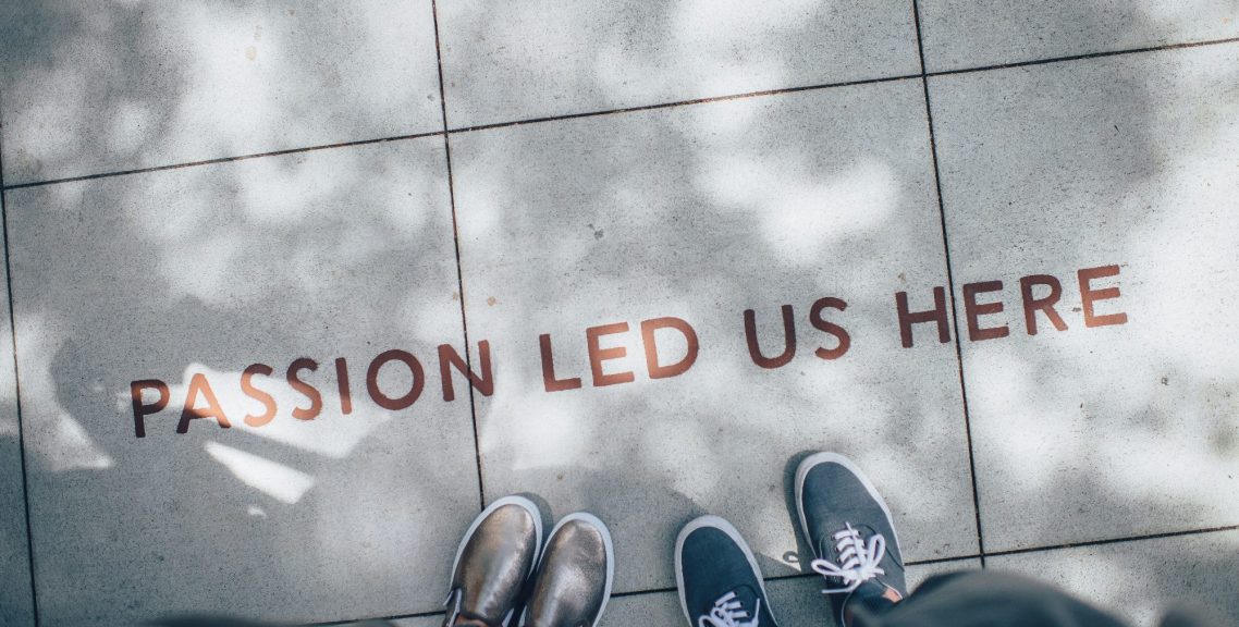 Shoes on pavement beneath the words Passion led us here